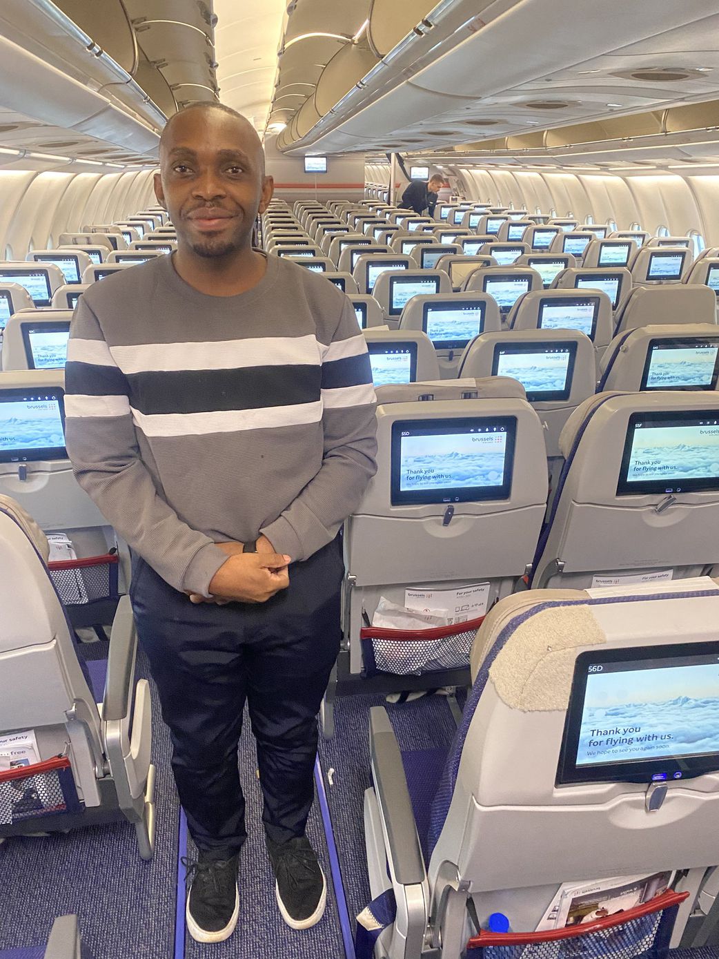 Dr. Jonathan Ssozi  Mulungi posing with the flight crew on a Brussels Airlines flight