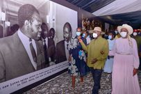 Museveni and his wife Janet walk through the museum