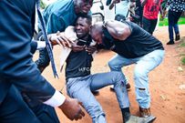 Bobi Wine being helped by his team