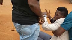 Bobi Wine being helped up by his team