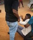 Bobi Wine being helped up by his team