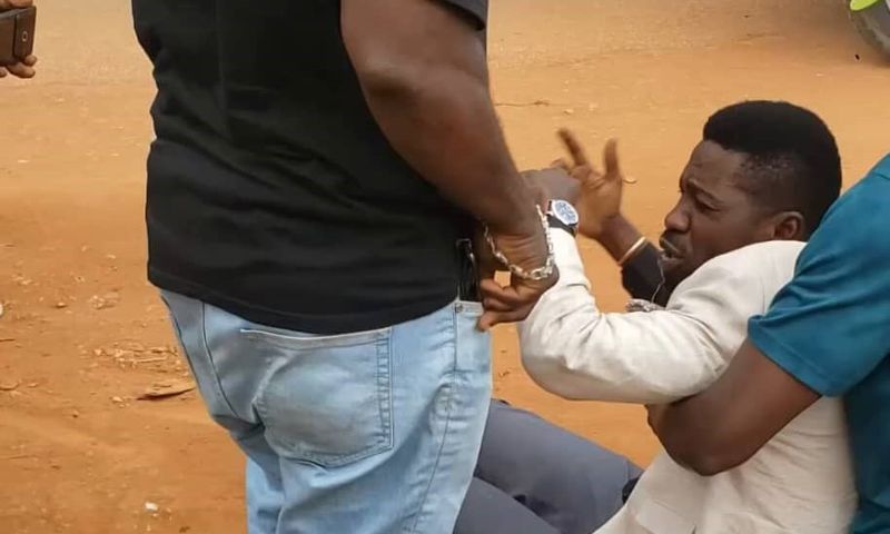 Bobi Wine being helped up by his team