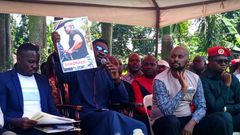Bobi WIne displays a photo of one of the police officers involved in the Tuesday incident