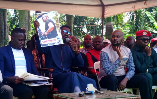 Bobi WIne displays a photo of one of the police officers involved in the Tuesday incident