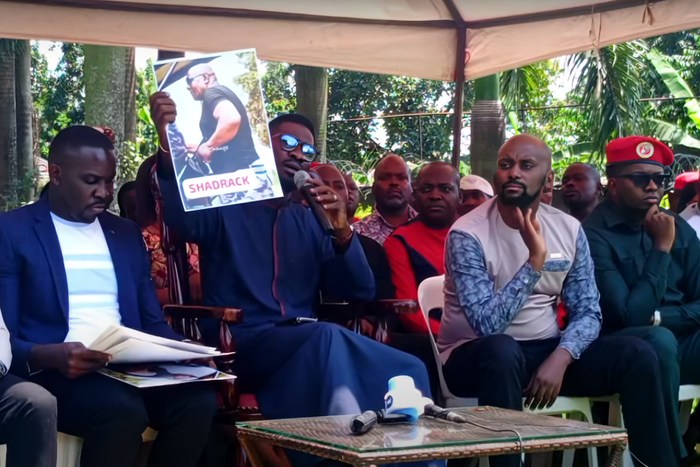 Bobi WIne displays a photo of one of the police officers involved in the Tuesday incident