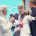 Pastor Benny Hinn prays for a woman at the crusade