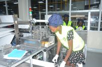 An employee at East African Medica Vitals