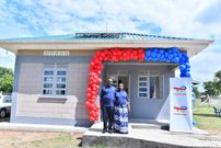 A family posing in front of their new home