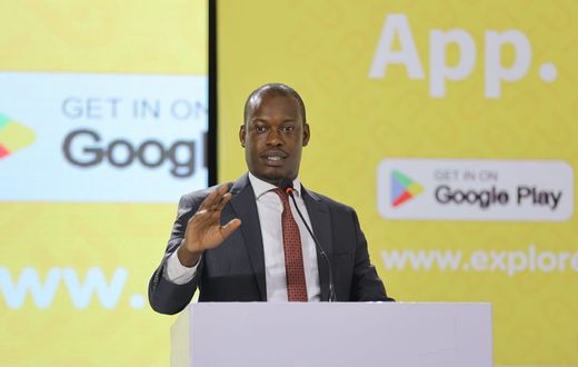 Minister Martin Mugarra speaking at the Explore Uganda app launch