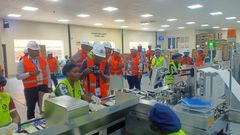 MPs touring a production line at the East African Medical Vitals