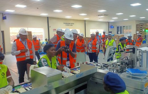 MPs touring a production line at the East African Medical Vitals