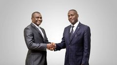 Daniel Ligyalingi, outgoing board chairman (L) and Joseph Lubaale Bagabo the new board chairman (R)