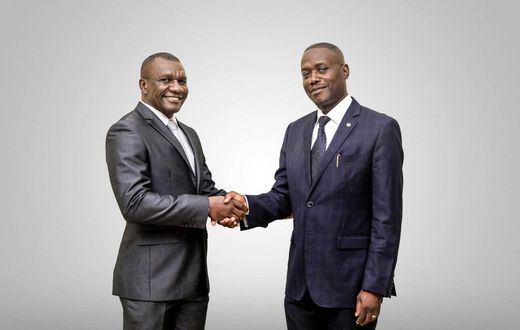 Daniel Ligyalingi, outgoing board chairman (L) and Joseph Lubaale Bagabo the new board chairman (R)