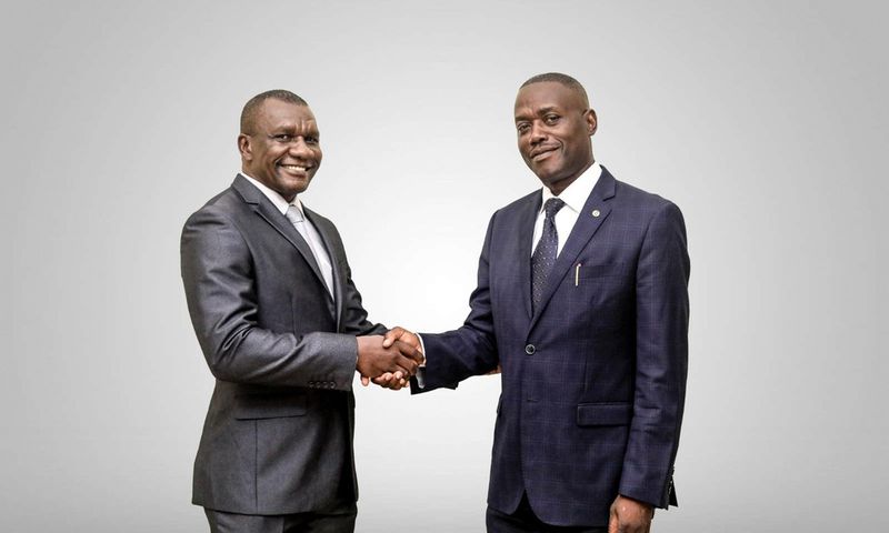 Daniel Ligyalingi, outgoing board chairman (L) and Joseph Lubaale Bagabo the new board chairman (R)