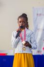 Racheal Nafula from Little Rock School poses for a photo with her trophy as the overall top scholar with 1178 books read earning herself a total of 20,680 points during the World Readers Awards at Kenya National Library.