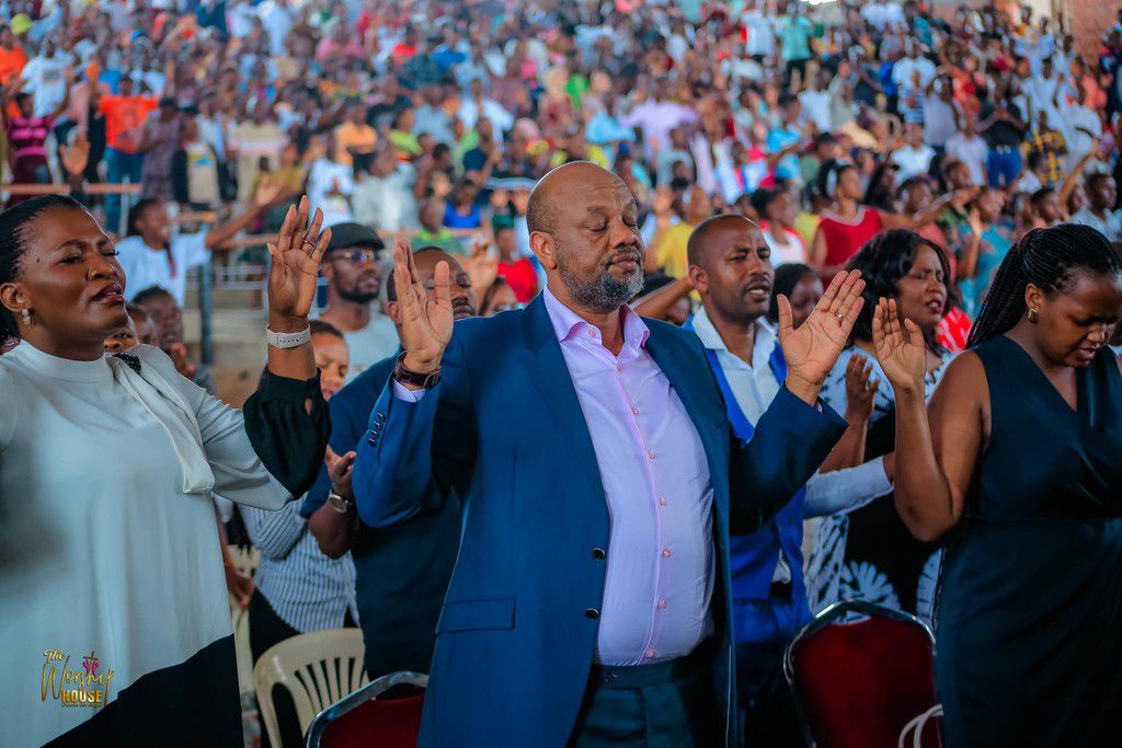 Toyota praying with congregants in Nansana