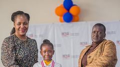 Racheal Nafula from Little Rock School poses for a photo with her mother and the Deputy Director - Cataloguing, classification, and Distribution, KNLS Betty Kalugho during the World Readers Awards at Kenya National Library.