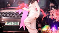 Sheilah Gashumba poses in front of her Range Rover
