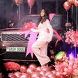 Sheilah Gashumba poses in front of her Range Rover