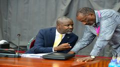 Deputy Speaker, Tayebwa (L) confers with Jim Kabeho during the meeting at Parliament