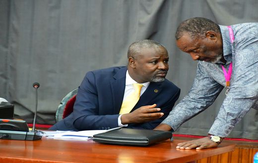 Deputy Speaker, Tayebwa (L) confers with Jim Kabeho during the meeting at Parliament