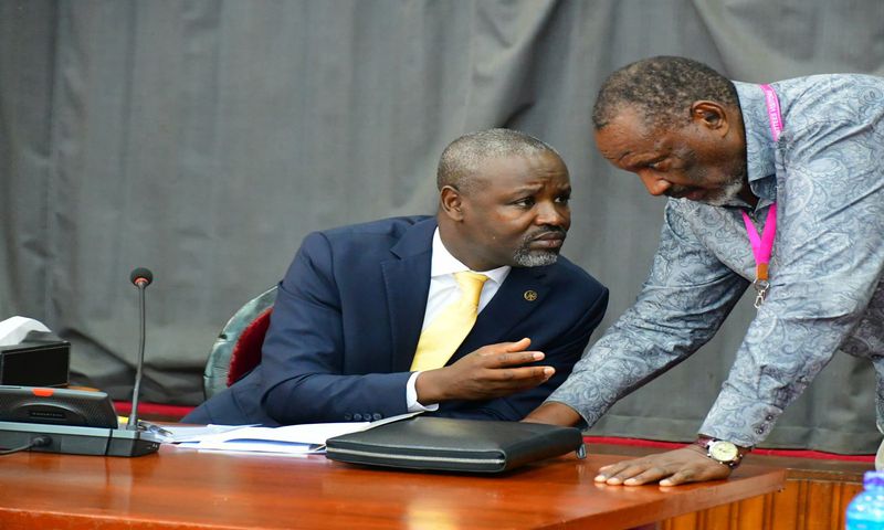 Deputy Speaker, Tayebwa (L) confers with Jim Kabeho during the meeting at Parliament