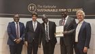 Julius Kakeeto (2nd R), PostBank Uganda Managing Director holding the Sustainability Certificate from EOSD