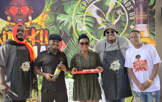 (2nd Left) Uganda Waragi Brand Manager Hillary Baguma and MC Uganda (1st right) Ndeku Nyama Choma organizer at the the launcg of the 4th edition of the festival at Shisa Nyama Village