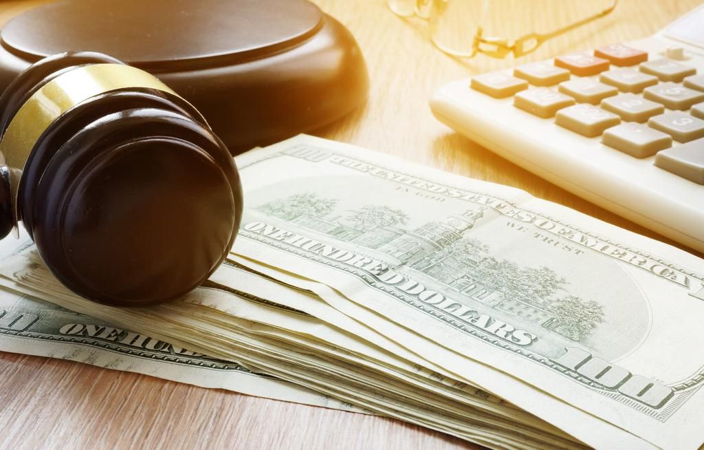 A stock image shows a gavel, keyboard, and dollar notes.designer491/Getty Images