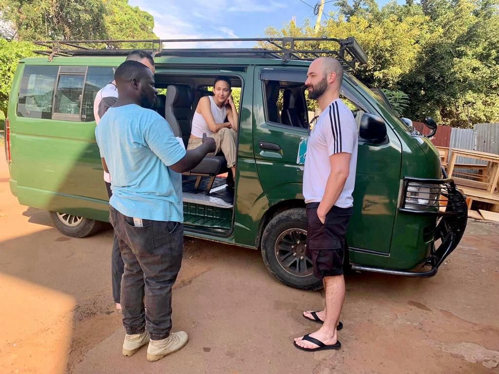 A driver emphasises a point to a tourist