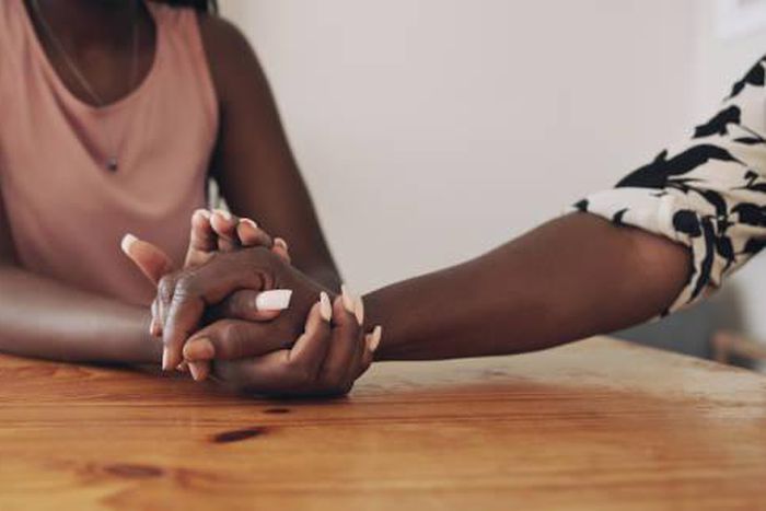 A person comforting a bereaved person