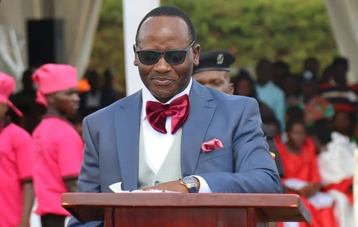 Mathias Mpuuga speaking at the thanksgiving event