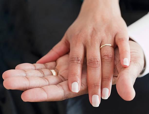 Rings on couples' fingers