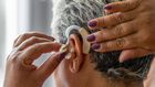 An elderly woman wearing hearing aid