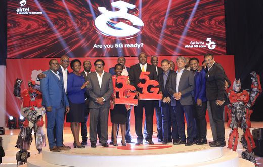 Dr Chris Baryomunsi (C), The Minister of ICT and National Guidance, Airtel Uganda, Managing Director, manoj murali (4th L), Uganda Communications Commission Executive Director, Eng Irene Kaggwa Sewankambo (5th L), tog