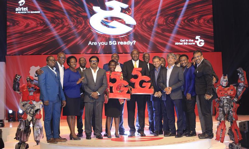 Dr Chris Baryomunsi (C), The Minister of ICT and National Guidance, Airtel Uganda, Managing Director, manoj murali (4th L), Uganda Communications Commission Executive Director, Eng Irene Kaggwa Sewankambo (5th L), tog