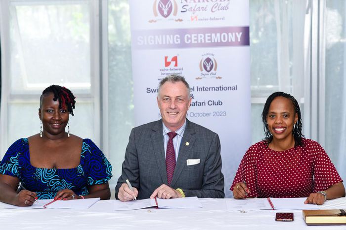 Mukawa (Hotels) Holdings Ltd Directors Ms Clare Njeri Githunguri (left) and Ms Lilian Joy Nyagaki Githunguri (right) exchange the hotel management agreements with Swiss-Belhotel International’s Senior Vice President Laurent Voivenel (centre)