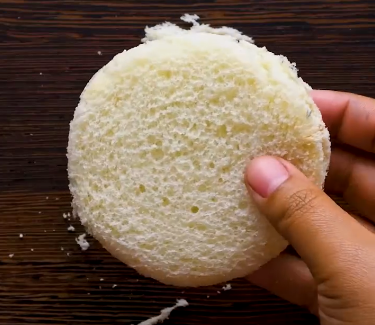 Cutting out a patch of bread to use as a scrub