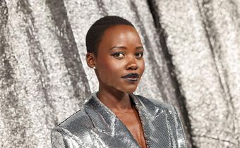 Oscar winner Lupita Nyong'o posed against the silver backdrop in a sequinned silver blazer dress.