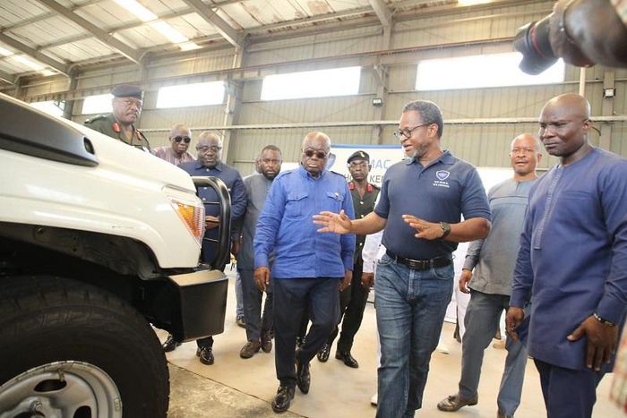 Mr-Kenneth-Akibate-middle-showing-some-of-the-assembled-vehicles-to-President-Akufo-Addo-on-tour-of-the-facility