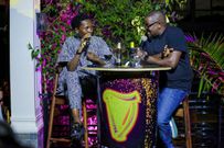 Azawi and Benon engage in conversation at the listening party