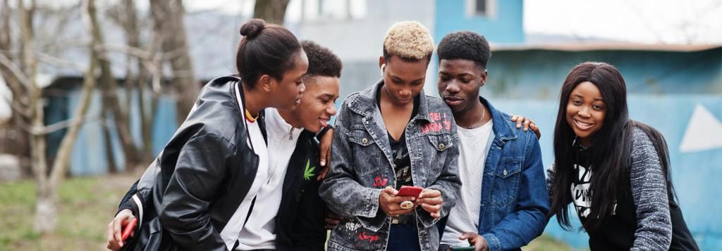 Young people having fun and using technology