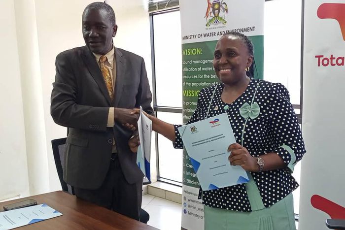 Alfred Okot Okidi, Permanent Secretary of MWE, and Mariam Nampeera Mbowa, Deputy General Manager of TotalEnergies EP Uganda at the MOU signing