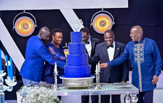 dfcu Bank management, and Guest of honor cutting cake during dfcu bank's 60 year anniverssary celebrations at Mestil Hotel