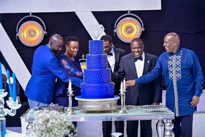 dfcu Bank management, and Guest of honor cutting cake during dfcu bank's 60 year anniverssary celebrations at Mestil Hotel