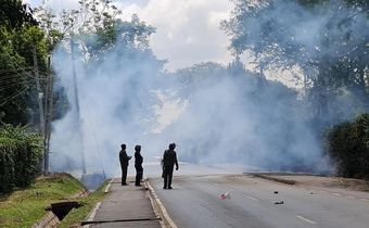 Police look on after launching tear gas