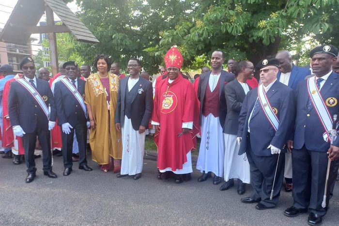 Charles Peter Mayiga and Archbishop Semogerere pose with Christians after the Martyrs Day mass in Boston