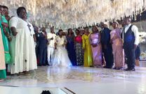 The bride and groom posing with some of their guest at the reception at Kololo