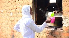 A student getting porridge from the Kitchen at Barakala Seed Secondary School