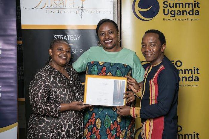 Next Media's Lilian Mutesi receiving her certificate of attendance at the CEO Apprenticeship Program (CAP)program